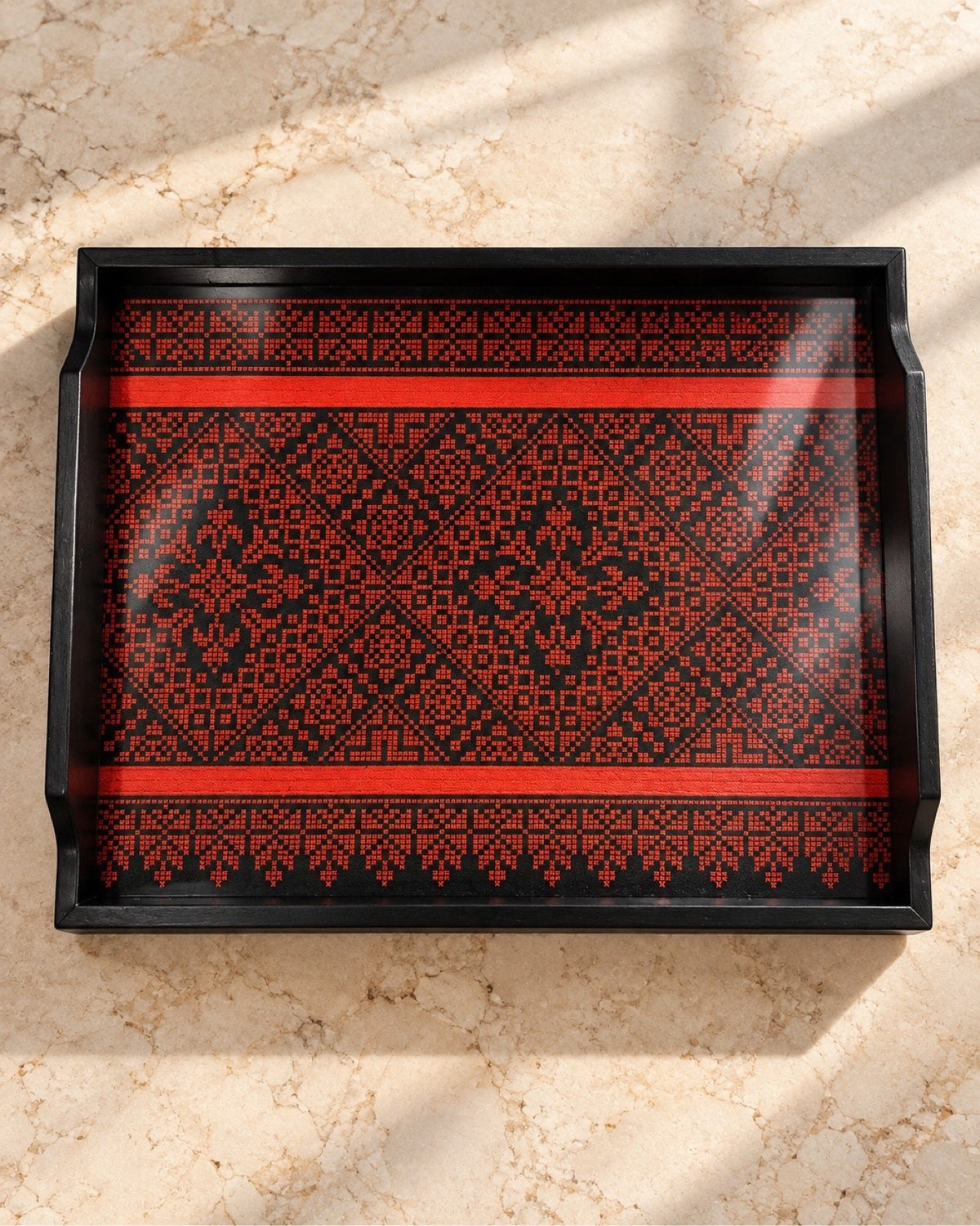 Palestinian tatreez wooden tray, top view on marble